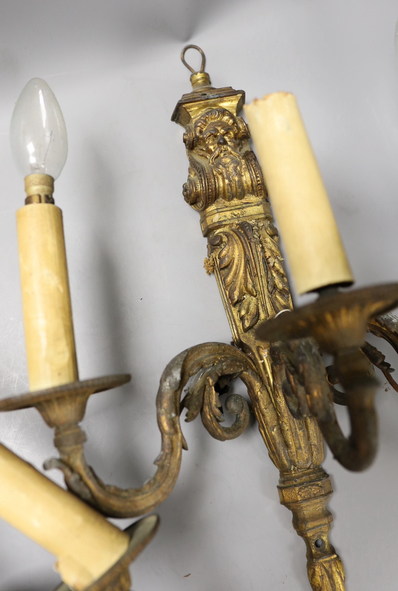 A pair of Baroque style ormolu three branch wall lights